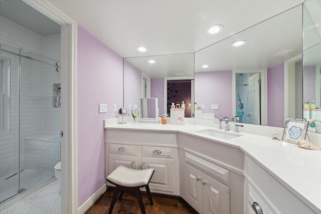 full bathroom with wood finished floors, a stall shower, vanity, toilet, and recessed lighting