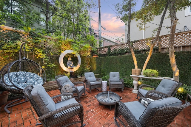 view of patio featuring a fenced backyard and an outdoor living space with a fire pit