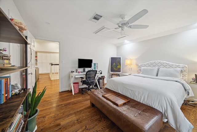 bedroom featuring a ceiling fan, wood finished floors, and visible vents