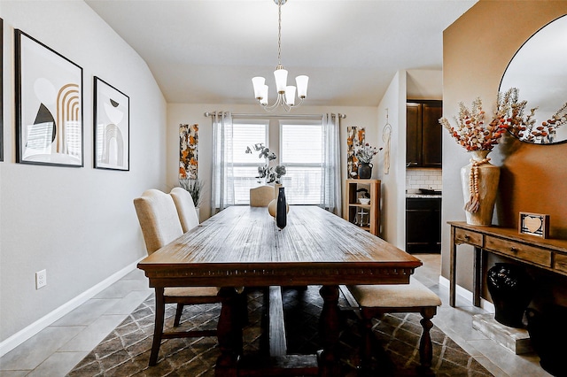 dining area featuring baseboards and an inviting chandelier