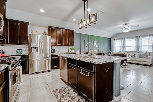 kitchen featuring a sink, vaulted ceiling, visible vents, a ceiling fan, and appliances with stainless steel finishes