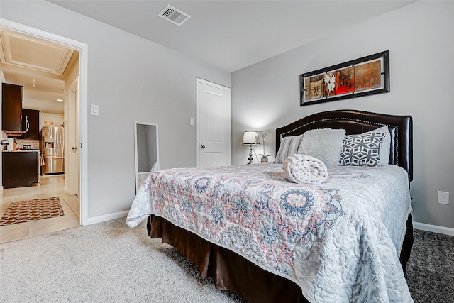 bedroom with attic access, stainless steel fridge with ice dispenser, light colored carpet, baseboards, and visible vents