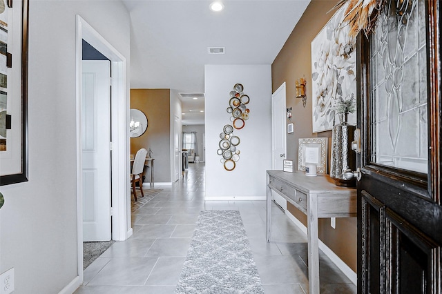 entryway featuring baseboards, visible vents, and light tile patterned floors