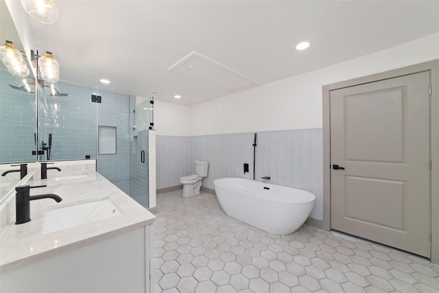 11931 S Red Cedar Cir, The Woodlands, TX 77380 - bathroom with a stall shower, double vanity, a freestanding tub, a wainscoted wall, and toilet