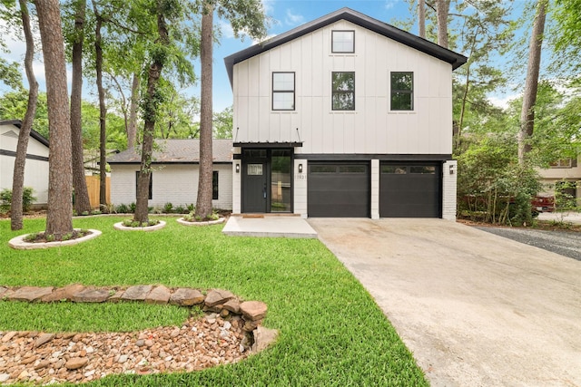 modern inspired farmhouse featuring board and batten siding, an attached garage, driveway, and a front lawn