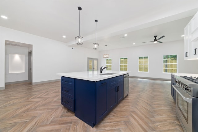 11931 S Red Cedar Cir, The Woodlands, TX 77380 - kitchen with appliances with stainless steel finishes, blue cabinets, a sink, light countertops, and open floor plan