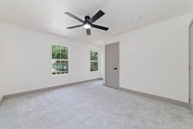 11931 S Red Cedar Cir, The Woodlands, TX 77380 - empty room featuring a ceiling fan, light carpet, baseboards, and a smoke detector