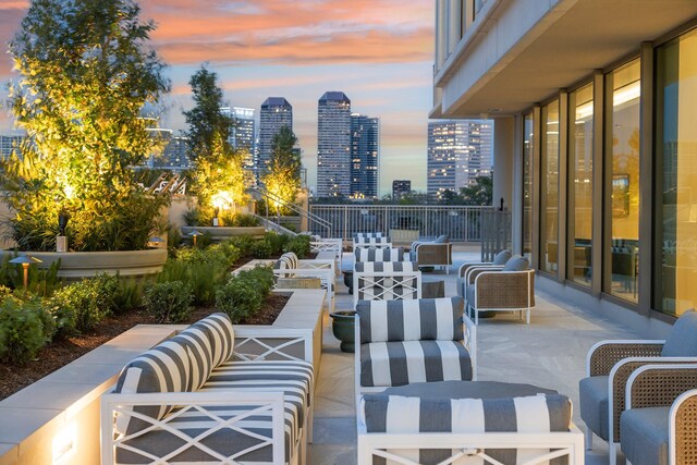 view of patio / terrace with a view of city and an outdoor living space