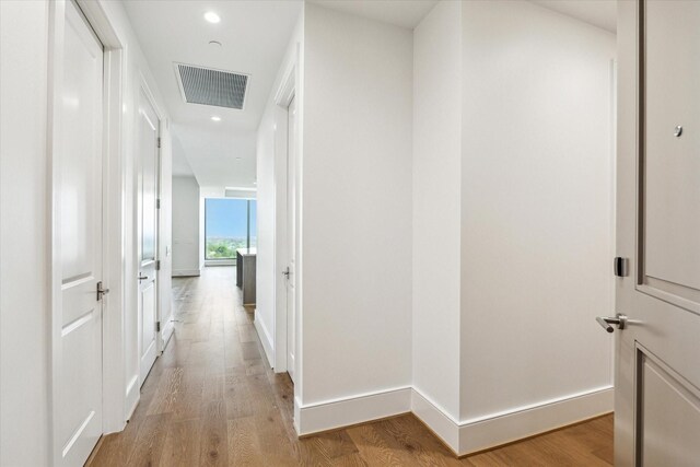corridor with visible vents, recessed lighting, light wood finished floors, and baseboards