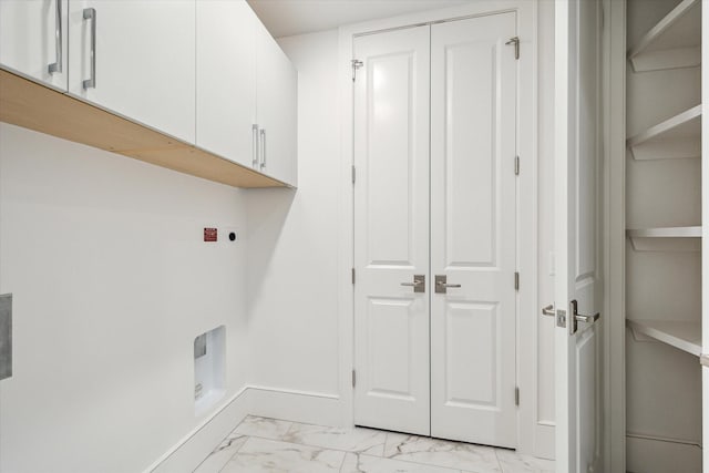 laundry room featuring cabinet space, electric dryer hookup, and marble finish floor