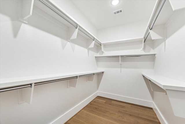 spacious closet featuring visible vents and wood finished floors