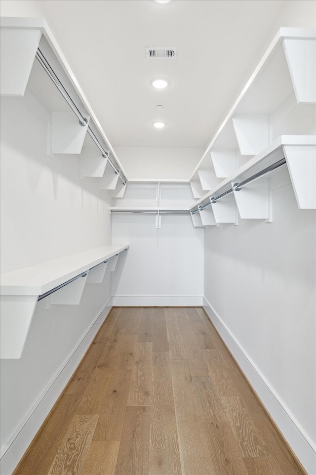 spacious closet with wood finished floors and visible vents