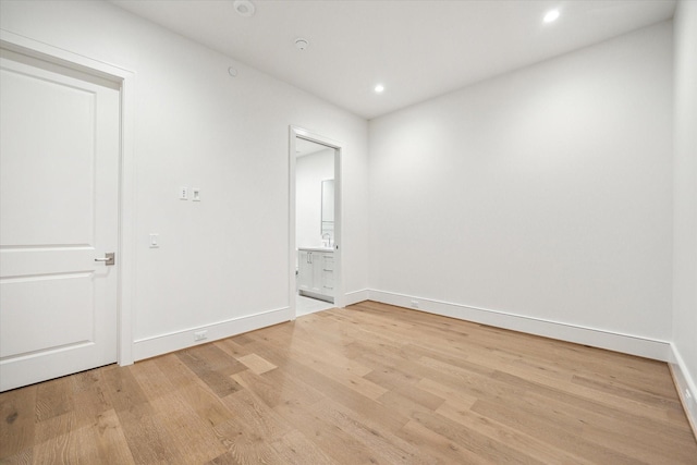 unfurnished room featuring recessed lighting, baseboards, and light wood finished floors