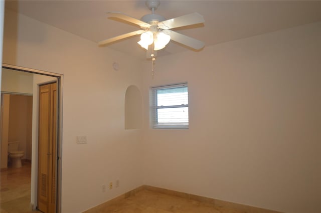 unfurnished room featuring light tile patterned flooring and a ceiling fan