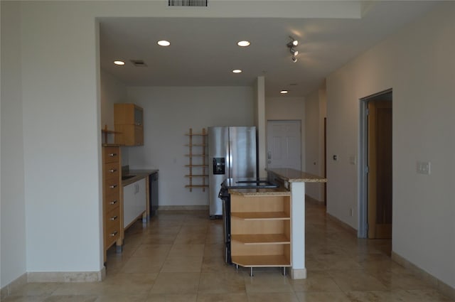 kitchen featuring open shelves, a kitchen island with sink, stainless steel fridge, and recessed lighting