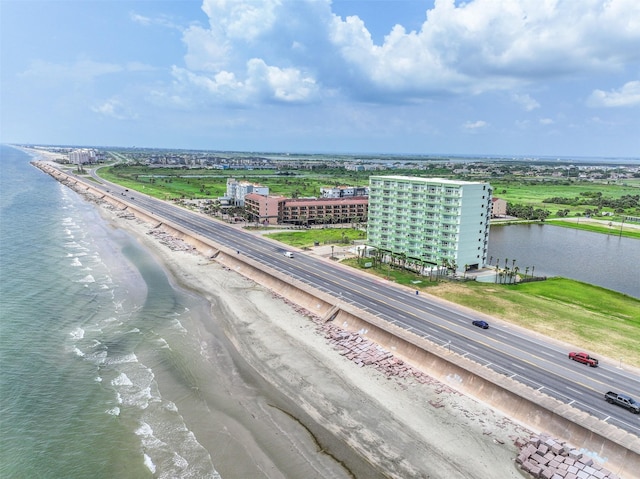 drone / aerial view with a beach view and a water view