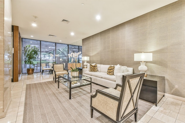 living room with floor to ceiling windows, wallpapered walls, recessed lighting, tile patterned flooring, and visible vents