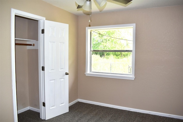 12112 Fm-457, Cedar Lane, TX 77415 - unfurnished bedroom with dark carpet, baseboards, and a ceiling fan