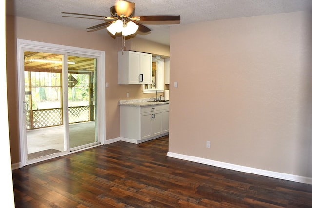 12112 Fm-457, Cedar Lane, TX 77415 - unfurnished room with ceiling fan, baseboards, a sink, dark wood-type flooring, and a textured ceiling