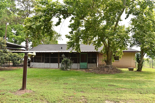 12112 Fm-457, Cedar Lane, TX 77415 - back of house featuring a sunroom, a yard, and brick siding