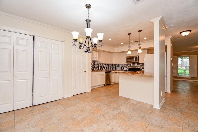 kitchen with stone tile flooring, a notable chandelier, decorative backsplash, ornamental molding, and appliances with stainless steel finishes