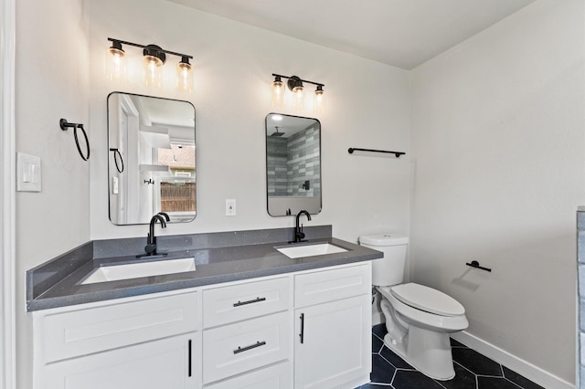 full bath featuring tile patterned flooring, toilet, baseboards, and a sink