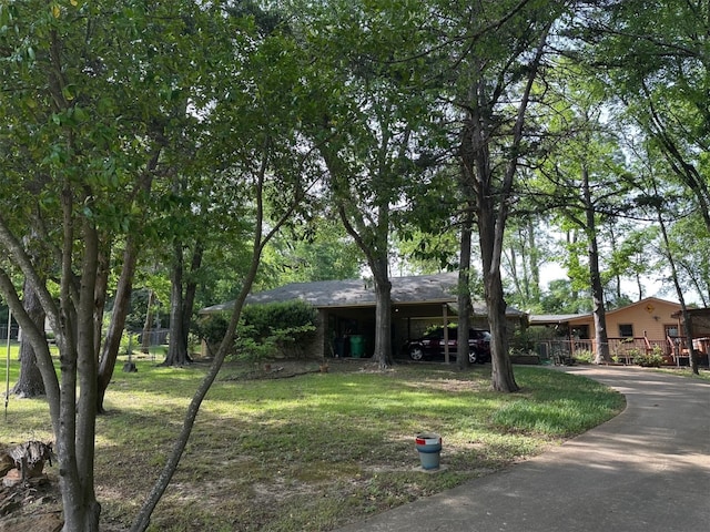 view of front of house with fence, driveway, and a front yard