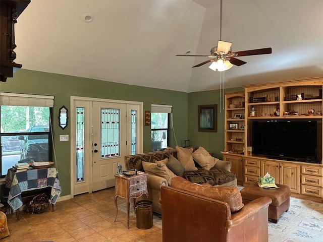 living area with vaulted ceiling, a wealth of natural light, baseboards, and ceiling fan