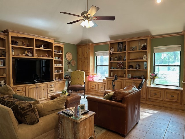 living area featuring lofted ceiling, a ceiling fan, and light tile patterned floors