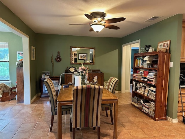 dining area featuring visible vents, baseboards, ceiling fan, and light tile patterned floors