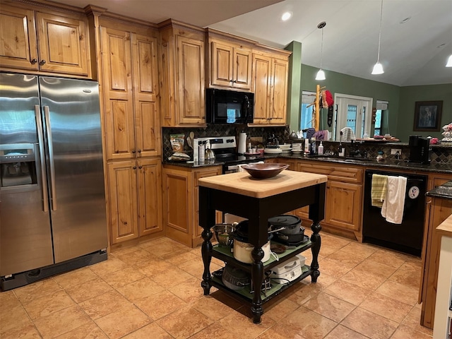 kitchen with black appliances, decorative backsplash, a sink, and dark countertops