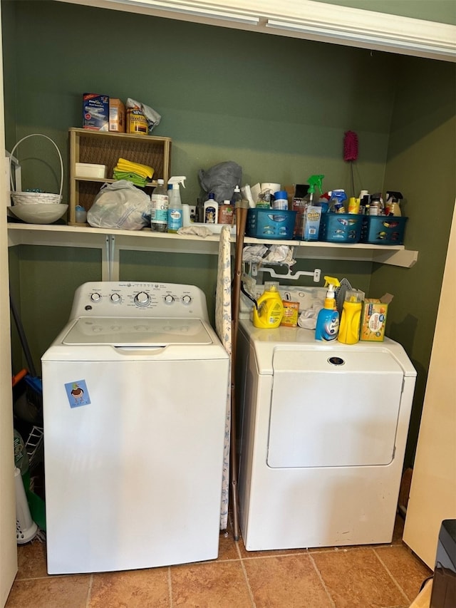 clothes washing area with washer and clothes dryer and laundry area