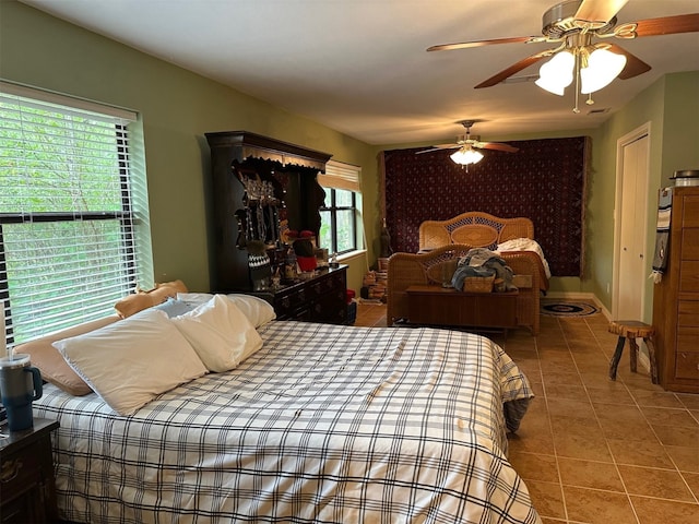 tiled bedroom featuring a ceiling fan