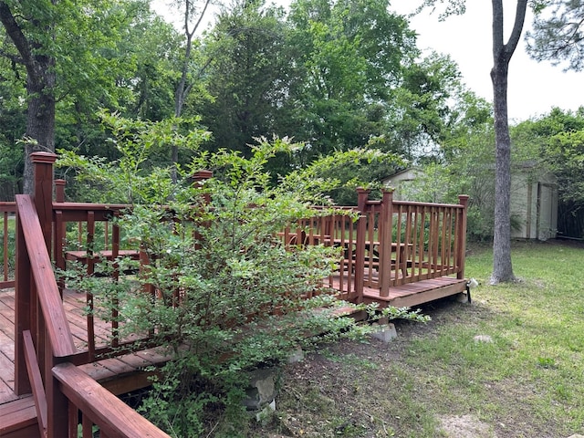 deck with a lawn, an outbuilding, and a storage shed