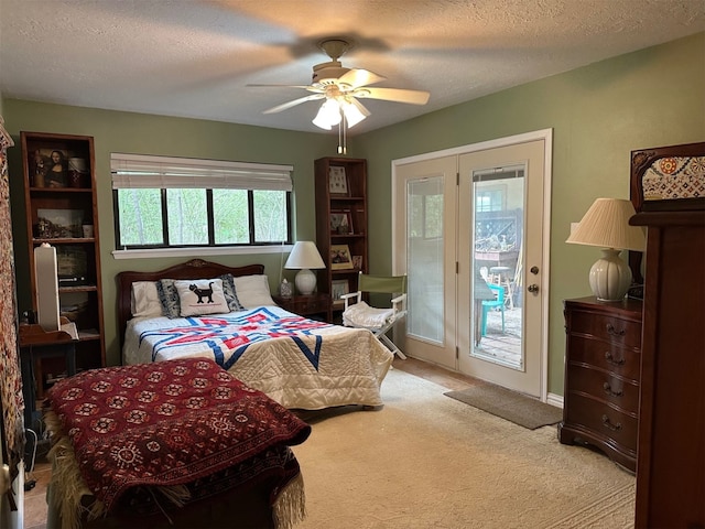 carpeted bedroom featuring ceiling fan, a textured ceiling, and access to outside