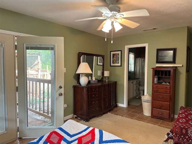 bedroom with tile patterned flooring, visible vents, access to exterior, baseboards, and a textured ceiling