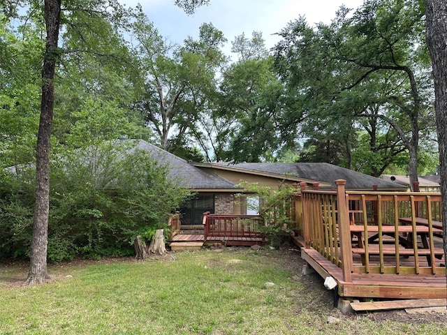 exterior space featuring a lawn and a wooden deck