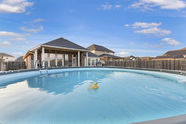 view of pool featuring a fenced backyard, a fenced in pool, and a residential view