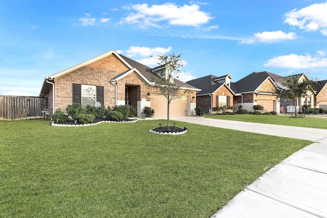 single story home featuring brick siding, a front yard, concrete driveway, and fence