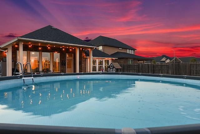 view of swimming pool featuring a fenced in pool and fence