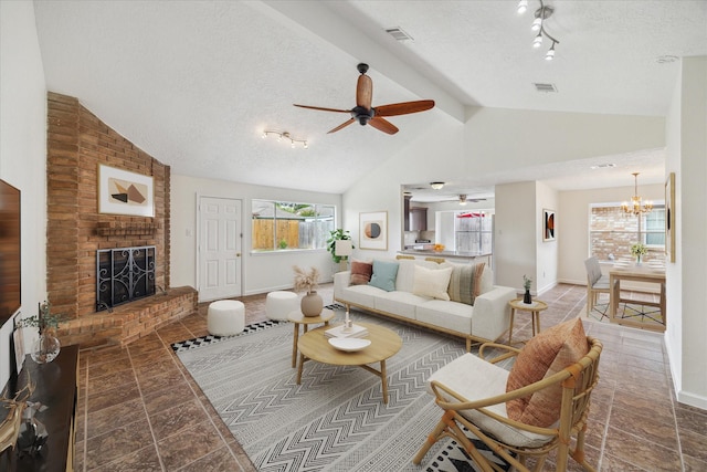 living room with ceiling fan with notable chandelier, vaulted ceiling, visible vents, and a wealth of natural light