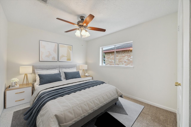 carpeted bedroom with baseboards and ceiling fan