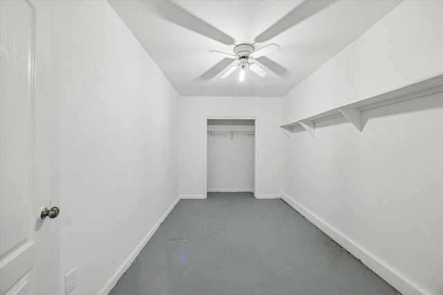 spacious closet with a ceiling fan