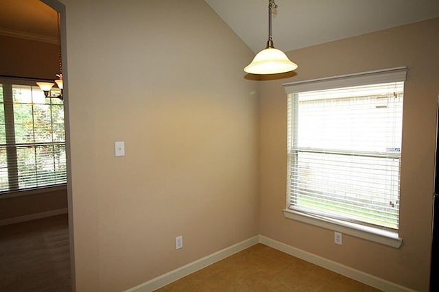 spare room with baseboards, arched walkways, lofted ceiling, and light tile patterned flooring