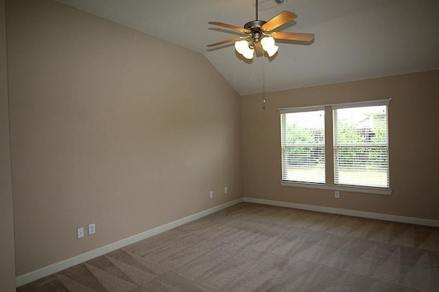 unfurnished room with baseboards, ceiling fan, lofted ceiling, and light colored carpet