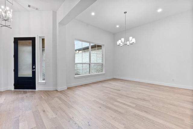 entrance foyer with a chandelier, light wood-style floors, visible vents, and baseboards