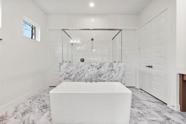 full bathroom featuring a stall shower, marble finish floor, a soaking tub, baseboards, and recessed lighting