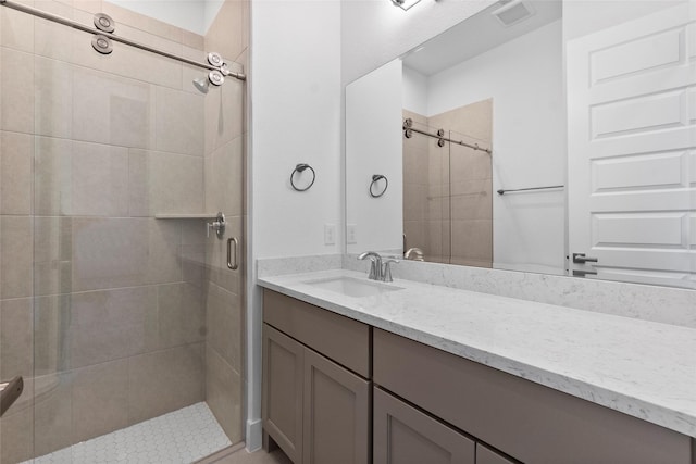 full bath featuring vanity, visible vents, and a stall shower