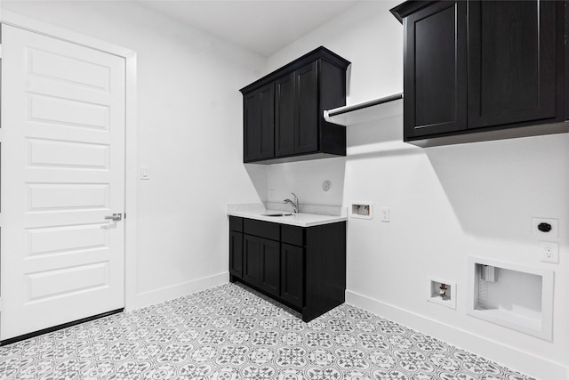 laundry room with a sink, electric dryer hookup, cabinet space, baseboards, and washer hookup