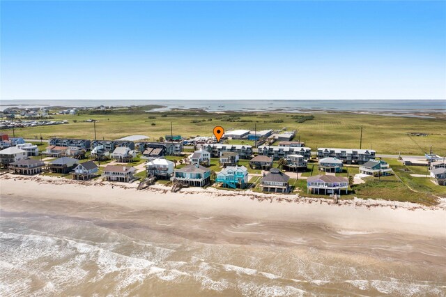 bird's eye view featuring a beach view and a water view